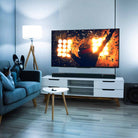 Klipsch Flexus Core 200 3.1.2-Channel Dobly Atmos Soundbar on media stand with TV